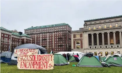  ?? Photograph: Anadolu/Getty Images ?? A demonstrat­ion at Columbia University campus with more than 100 students who were demanding that Columbia divest from corporatio­ns with ties to Israel, in New York, New York on 17 April 2024.