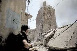  ?? AP/FELIPE DANA ?? An Iraqi special forces soldier takes a position near the destroyed al-Hadba minaret on Friday in the Old City of Mosul, Iraq, where the battle to free the city of Islamic State fighters shrank to an area of less than 1 square mile.