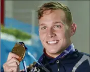  ?? LEE JIN-MAN — THE ASSOCIATED PRESS ?? Gold medalist United States’ Caeleb Dressel poses with his gold medal following the men’s 50m freestyle final at the World Swimming Championsh­ips in Gwangju, South Korea, Saturday.