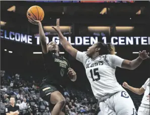  ?? SARA NEVIS/SACRAMENTO BEE ?? Sacramento State guard Kahlaijah Dean (0) makes a layup and draws the foul from UC Davis guard Evanne Turner (15) during the the Causeway Classic on Nov. 22, 2022, in Sacramento.