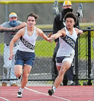  ?? SARAH GORDON/THE DAY ?? Ledyard’s Ramon Streckfuss passes off the baton to Jackson Poulton for the final leg of the 4x100meter relay during Wednesday’s season-opening track and field meet against Montville on the Colonels’ newly-renovated track. Ledyard won the event and beat the Indians. The Ledyard girls also won to give the Colonels a sweep. Visit www.theday.com to view a photo gallery.