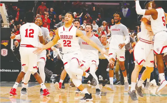  ?? DILIP VISHWANAT/GETTY IMAGES ?? Saskatoon’s Ja’shon Henry, front and centre, cracked the Bradley Braves’ basketball roster as a freshman, and played in the NCAA’S March Madness tournament, two years after his hoops-loving father died of cancer. Above, the Braves celebrate after beating Northern Iowa in the MVC tournament prior to the NCAA event.