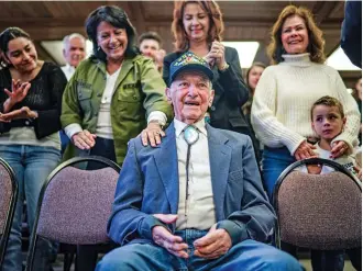  ?? GABRIELA CAMPOS/THE NEW MEXICAN ?? Placido Borrego, a 99-year-old veteran who served in the U.S. Army in World War II and during the Korean and Vietnam wars, is honored Wednesday by his family and friends at City Hall.