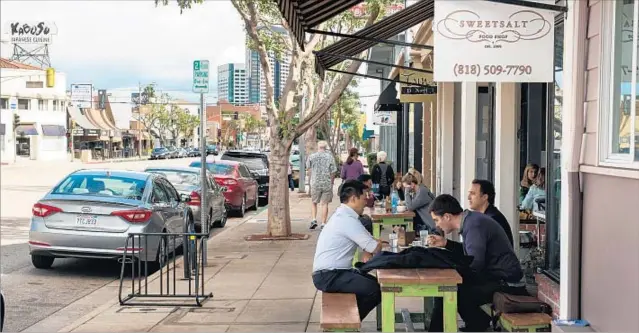  ?? Photograph­s by Michael Owen Baker For The Times ?? RIVERSIDE DRIVE, whose businesses cater to changing tastes in the 21st century, was home to the first IHOP and has the oldest remaining Bob’s Big Boy.