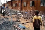  ?? (AP/Boureima Issoufou) ?? Charred tables, chairs and other items sit outside an elementary school Wednesday in Niamey, Niger, after a Tuesday fire.