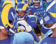  ?? Robert Gauthier / TNS ?? Los Angeles Rams defensive end Aaron Donald, center, rallies teammates before taking on the Tampa Bay Buccaneers in the NFC divisional playoff at Raymond James Stadium on Jan. 23.