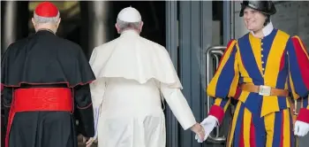  ?? ALESSANDRA TARANTINO/THE ASSOCIATED PRESS ?? Pope Francis greets a Vatican Swiss Guard as he arrives for a morning session of a twoweek synod on family issues at the Vatican on Thursday.