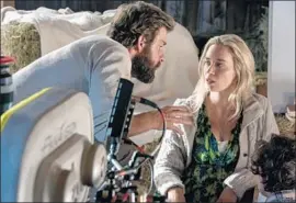  ?? Jonny Cournoyer Paramount Pictures ?? DIRECTOR, co-writer, co-executive producer and co-star John Krasinski with wife and co-star Emily Blunt in the just-released horror-thriller “A Quiet Place.”