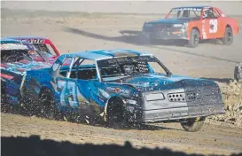  ??  ?? Hobby Stock race car driver Layne Bellm, 14, leads other competitor­s into Turn 4 during a heat raceatthee­l Paso County Raceway on Sept. 14. Later in the evening, Bellm won the season’s division track title.