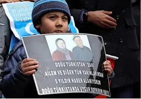  ?? ?? An Uyghur boy in Turkey holding a placard during a protest last year over human rights abuses in China’s Xinjiang region