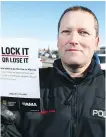  ?? JIM WELLS ?? With Alberta leading the country in auto thefts, Calgary Police Const. Elliott Lloyd helps launch the Lock It or Lose It driver awareness campaign at Sunridge Mall on Wednesday.