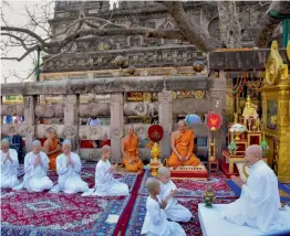  ?? — PTI ?? Novice Buddhist nuns get ordained under the sacred Maha Bodhi tree in Bodh Gaya on Friday.