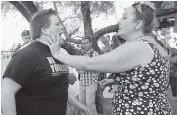  ?? AP ?? A Trump protester and Trump supporter get into an altercatio­n at a recent rally in Tucson, Arizona.