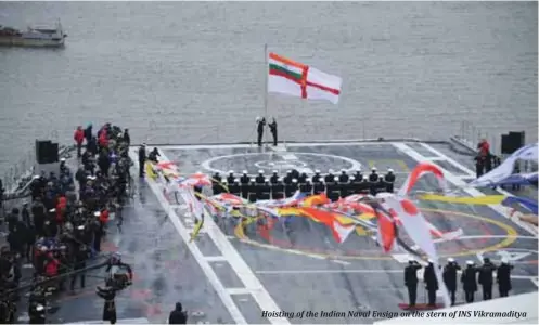  ??  ?? Hoisting of the Indian Naval Ensign on the stern of INS Vikramadit­ya