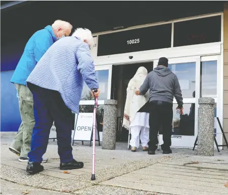  ?? NICK PROCAYLO ?? People enter the Fraser Health vaccinatio­n centre in Surrey on Monday. Anyone in B.C. over 90 can now book their COVID-19 shots.