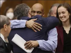  ?? CHRISTIAN GOODEN — ST. LOUIS POST- DISPATCH POOL PHOTO ?? Lamar Johnson embraces one of his attorneys on Tuesday after his murder conviction was vacated during a hearing in St. Louis.