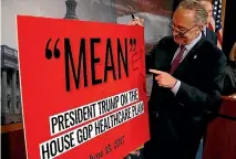  ?? PHOTO: REUTERS ?? Senate Minority leader Chuck Schumer (D-NY) points to a sign after Senate Republican­s unveiled legislatio­n that would replace Obamacare.