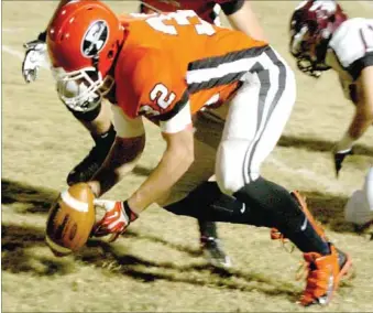  ?? MARK HUMPHREY ENTERPRISE-LEADER ?? Farmington’s Michael Lusher scoops up a Lincoln fumble on Friday. Both teams suffered turnovers as Lincoln prevailed 28-7 over their U.S. 62 rivals. The Wolves (9-1) and Cardinals (6-3-1) join league champion, Prairie Grove (9-1) in the playoffs this...