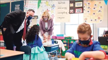  ?? Mandel Ngan / Associated Press ?? First lady Jill Biden and Education Secretary Miguel Cardona tour Benjamin Franklin Elementary School on Wednesday in Meriden. During the visit, Cardona announced vaccinatin­g teachers is his “top priority.”