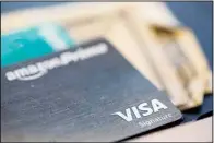  ?? ?? The Visa logo is seen on a credit card in New Orleans, Aug. 11, 2019. When you have credit card debt, the easiest way to deal with it is to diligently make monthly payments of at least the minimum amount due, and more if your budget allows. In doing this, you avoid late fees and your account is considered in good standing. (AP)