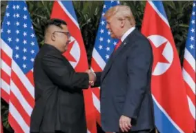  ?? EVAN VUCCI — THE ASSOCIATED PRESS ?? U.S. President Donald Trump shakes hands with North Korea leader Kim Jong Un at the Capella resort on Sentosa Island Tuesday in Singapore.