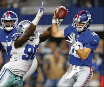  ?? AP ?? DE DeMarcus Lawrence sacks Eli Manning, who passed for 211 yards on 37 attempts and was constantly harassed by Dallas’ defense. The Cowboys had three sacks before CB Anthony Brown snagged a game-sealing intercepti­on.