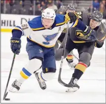  ?? (AP) ?? St. Louis Blues right wing Vladimir Tarasenko (91) and Vegas Golden Knights defenseman Shea Theodore (27) vie for the puck during the first period of an NHL hockey game, on Oct. 20, in Las Vegas.
