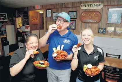  ?? SUSAN STOCKER/SOUTH FLORIDA SUN SENTINEL ?? Bridget Walsh-DeVita, from left, Tom Walsh and Chelsea Walsh on Tuesday at their family-run Wings Plus in Oakland Park, winner of the Let’s Wing It contest.