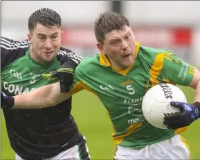  ??  ?? Wing-back Brian O’Neill breaks away from Hugh Byrne, the Blackhill captain.