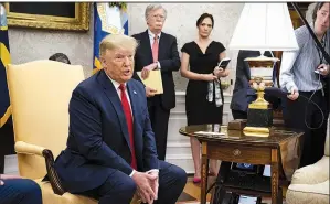  ?? The New York Times/DOUG MILLS ?? President Donald Trump, speaking with reporters Tuesday in the Oval Office, called Alex Acosta a “really great secretary of labor” and “very good” at his job. He sounded a sympatheti­c note, saying it’s not unusual to find past mistakes. With Trump are national security adviser John Bolton and White House press secretary Stephanie Grisham.