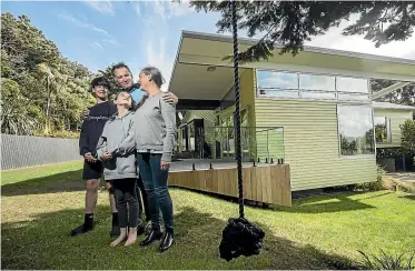  ?? PHOTO: ROBERT KITCHIN/STUFF ?? Chris and Sarah Keenan, with Jack, 13, and Maggie 10, renovated their ex-state house in Strathmore, Wellington, 12 years ago. The renovation was designed by local architect Ashley Cox.