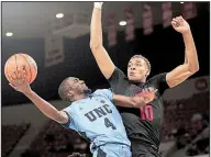  ??  ?? AP/TIMOTHY J. GONZALES
Arkansas’ Daniel Gafford (right) defends a shot by North Carolina’s Brandon Robinson during Friday’s game in the Phil Knight Invitation­al in Portland, Ore.