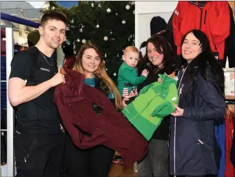  ??  ?? Jessica Clinton (fourth from left) purchasing a Regatta Aptitude green jacket for her son Rowen and a Classic Portwest Burgundy jacket for herself from Valerie Ashe, Conor Buckley and Sarah Clinton at Portwest, New Street, Killarney where they have an inside down Christmas Tree.