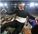  ?? ?? Fulham players lift Marco Silva in the air after sealing promotion