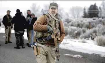  ?? Rick Bowmer Associated Press ?? AN ARMED MAN joins the January 2016 standoff with federal authoritie­s at the Malheur National Wildlife Refuge near Burns, Ore. Former Interior Secretary Sally Jewell says justice was not served in the case.