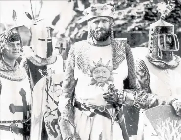  ??  ?? Terry Jones (right) in medieval garb as Sir Bedevere in Monty Python’s Holy Grail