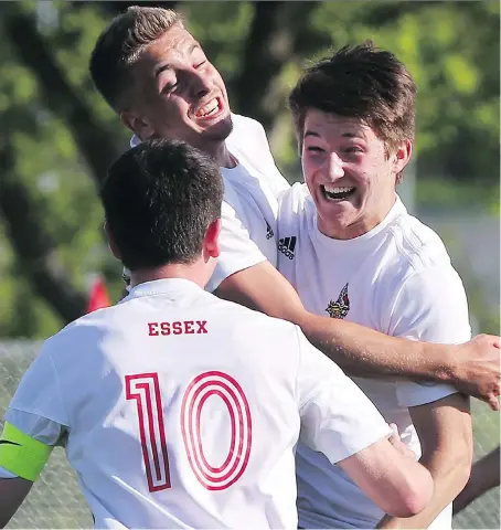  ?? DAN JANISSE ?? Jackson Moore, left, Amilio Acampora and Tyler Zsebok of Essex celebrate a first half goal against General Amherst during the WECSSAA boys’ AA soccer final on Thursday at the Academie Ste. Cecile. The Essex Red Raiders defeated the General Amherst...