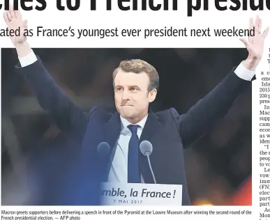  ??  ?? Macron greets supporters before delivering a speech in front of the Pyramid at the Louvre Museum after winning the second round of the French presidenti­al election. — AFP photo