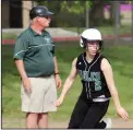  ??  ?? Elliot runner Lexie Juelch rounds third base in front of coach Mike Pontius.