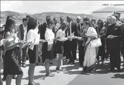  ?? PTI ?? President Ram Nath Kovind looks on as First Lady Savita Kovind offers sweets to students during their ceremonial welcome on his arrival in Madagascar, March 14