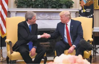  ?? Jim Watson / AFP / Getty Images ?? President Trump shakes hands with Italian Prime Minister Paolo Gentiloni at the White House. Trump will be traveling to Italy next month for the Group of Seven meeting.
