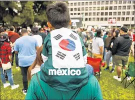  ?? Maria Alejandra Cardona Los Angeles Times ?? AYDEN MARTINEZ-SHIN, 4, wears a Mexico shirt decorated with a South Korean f lag to show support for both teams. Many crowds were evenly split.
