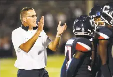  ?? Stephen Dunn / Associated Press ?? UConn coach Randy Edsall encourages his team during a timeout in an Aug. 30 game against UCF.