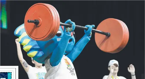  ?? Picture: AAP ?? Commonweal­th Games mascot Borobi entertains a crowd by lifting weights at the Carrara Sports and Leisure Centre.