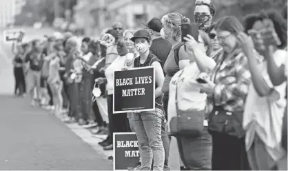  ?? PHOTOS BY JEFF ROBERSON, AP ?? Demonstrat­ors protest Sunday outside the St. Louis Police Department headquarte­rs in response to a not guilty verdict in the trial of former St. Louis police officer Jason Stockley, who was acquitted Friday in the 2011 killing of a black man following...