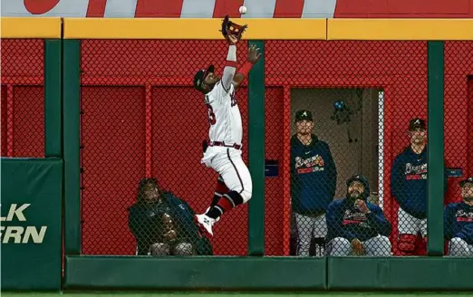  ?? KEVIN C. COX/GETTY IMAGES ?? Michael Harris II made a great catch for the Braves and started a game-ending double play against the Phillies.