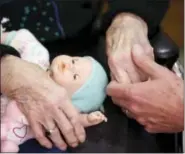  ?? CARLOS OSORIO — ASSOCIATED PRESS FILE PHOTO ?? In this April 14, 2016, file photo, a son, at right, holds his mother’s hand as they talk at her nursing home in Adrian, Mich. U.S. adults providing long-term care for elderly relatives have a shortage of medical training but plenty of commitment,...