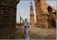  ?? (AP) ?? A worker sprays disinfecta­nt Tuesday at the Qutub Minar complex in New Delhi, India, in preparatio­ns for reopening the popular tourist site after months of lockdown. As the number of U.S. coronaviru­s deaths passes 600,000, the worldwide toll is about 3.8 million.