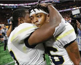  ?? CURTIS COMPTON / CCOMPTON@AJC.COM ?? Georgia Tech QB TaQuon Marshall (right) gets a well-deserved hug from Lance Austin after the Jackets lost in double overtime Monday.