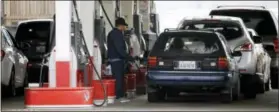 ?? DON RYAN — THE ASSOCIATED PRESS ?? Cars line up as an attendant pumps gas Wednesday at a station in Portland, Ore. Oregon is one of just two states where motorists aren’t allowed to pump their own gas. The other is New Jersey. Now the Oregon Legislatur­e appears ready to at least let...